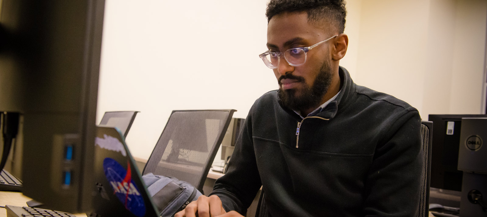A young man working on his laptop.