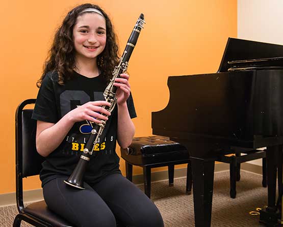 student holding clarinet