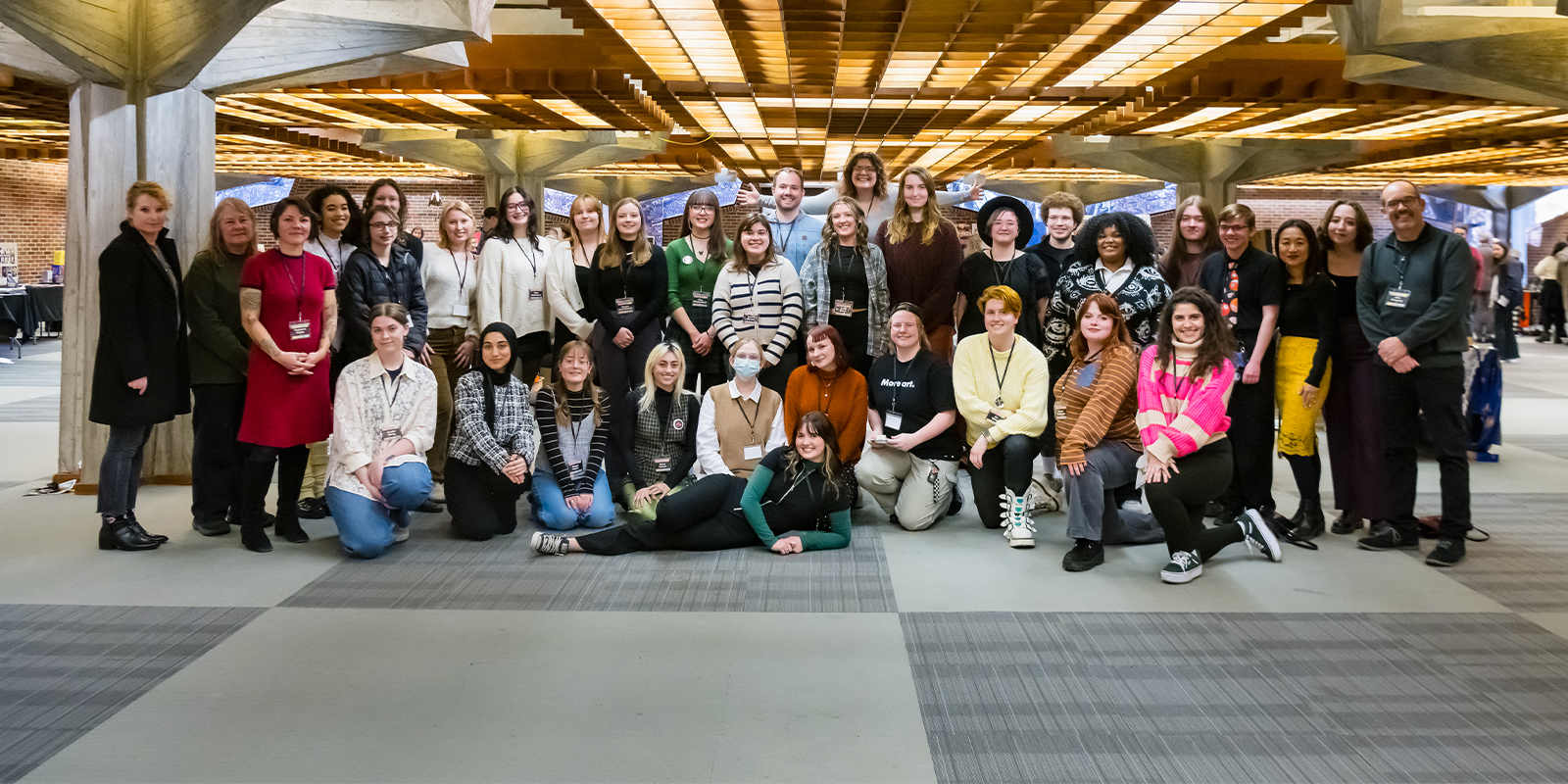 A group of people attending an art exhibition.