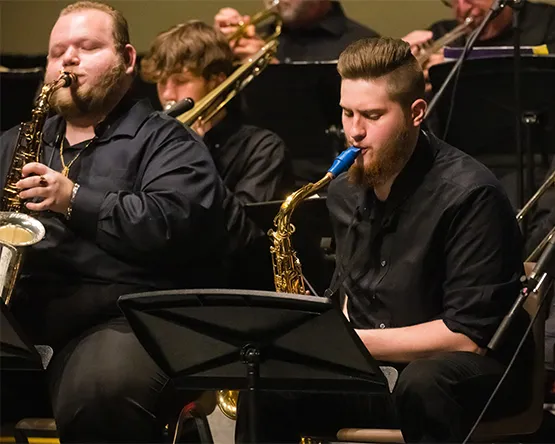 A student performs on saxophone in a jazz ensemble.