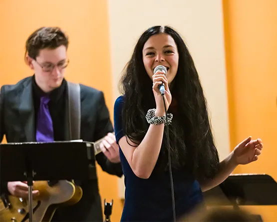 A student vocalist performing with a jazz combo.
