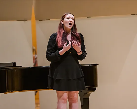 A student singing in a concert.