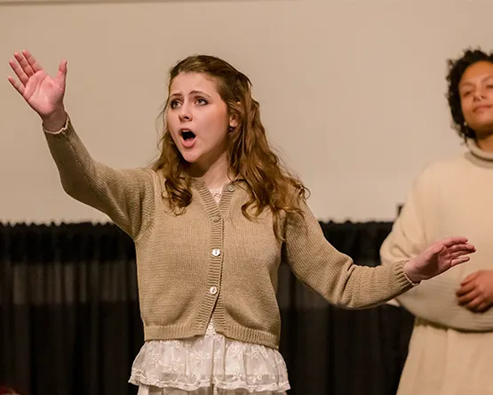 Student vocalist in an opera performance.