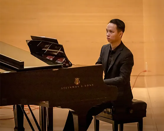 Student playing piano.
