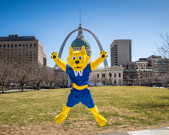 The Webster Gorlok jumping enthusiastically outside the Gateway Arch National Park in downtown St. Louis.