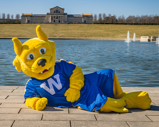 The Webster Gorlok posing outside the St. Louis Art Museum and lake.
