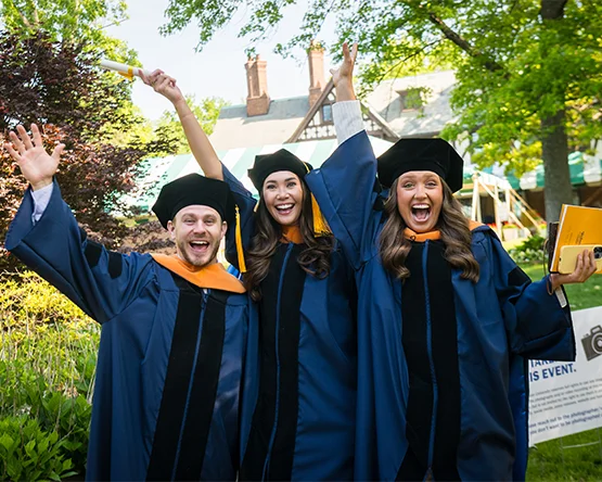 Graduate students celebrating at commencement.