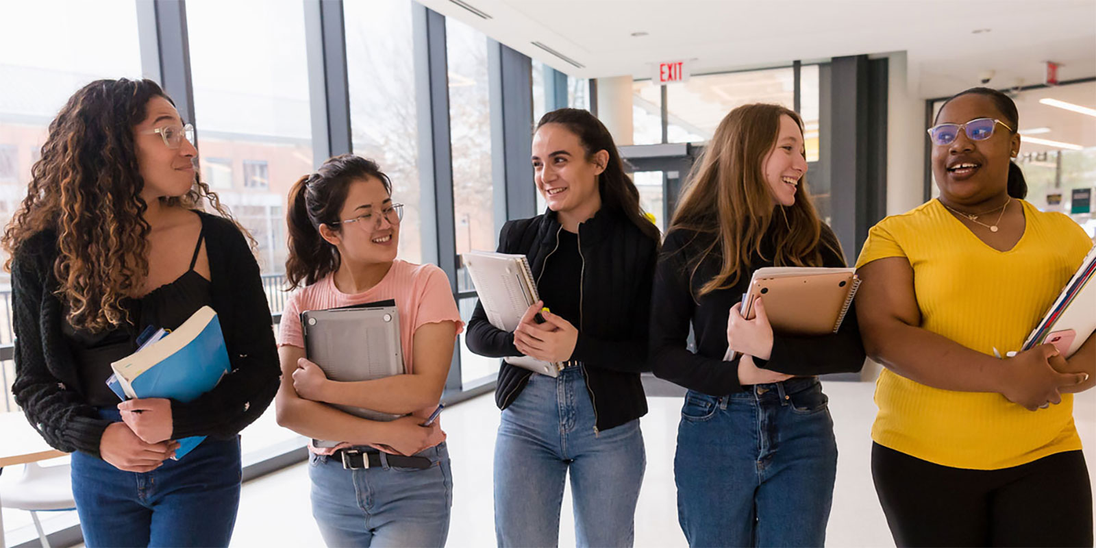 A diverse group of students walk outside together.
