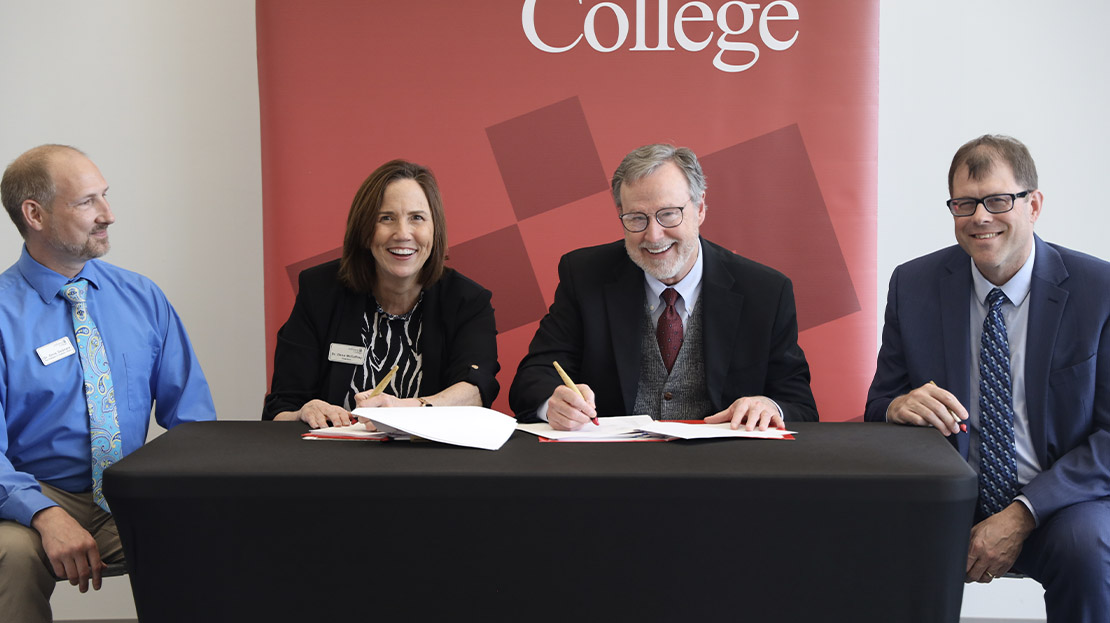 Webster President and Provost sign articulation agreements.