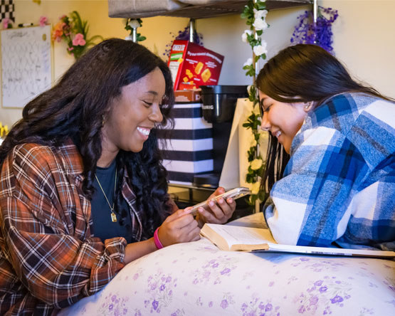 Webster students in their room on campus.