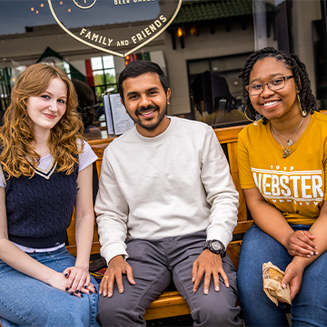 Three students enjoy time together off campus.