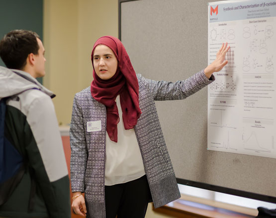 Researcher presenting during Research Across Disciplines event held each December.
