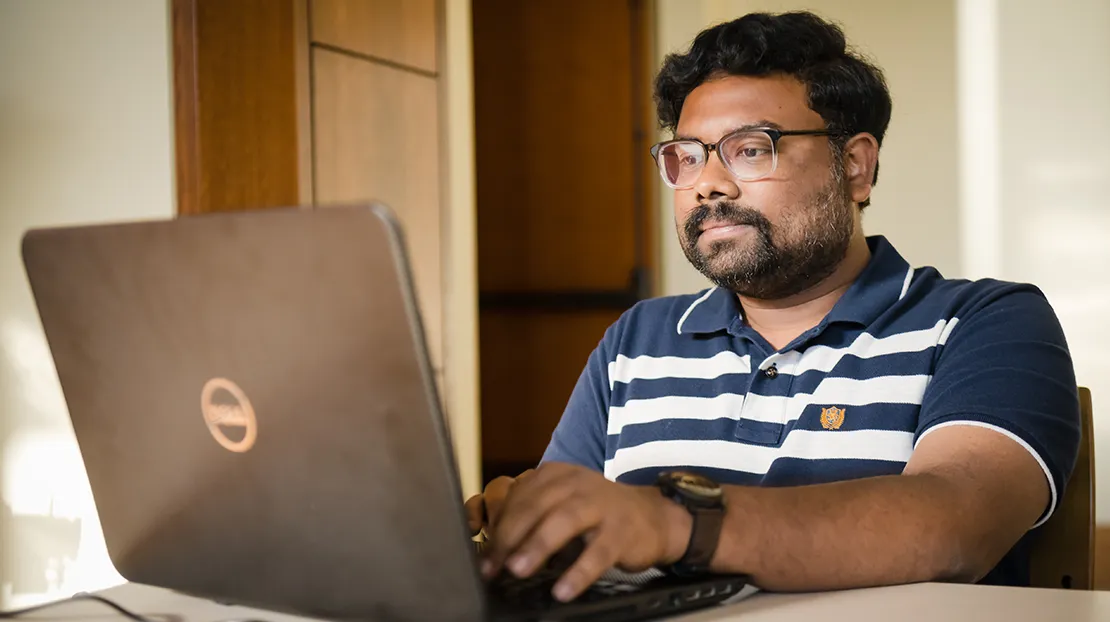 Male student working on computer.