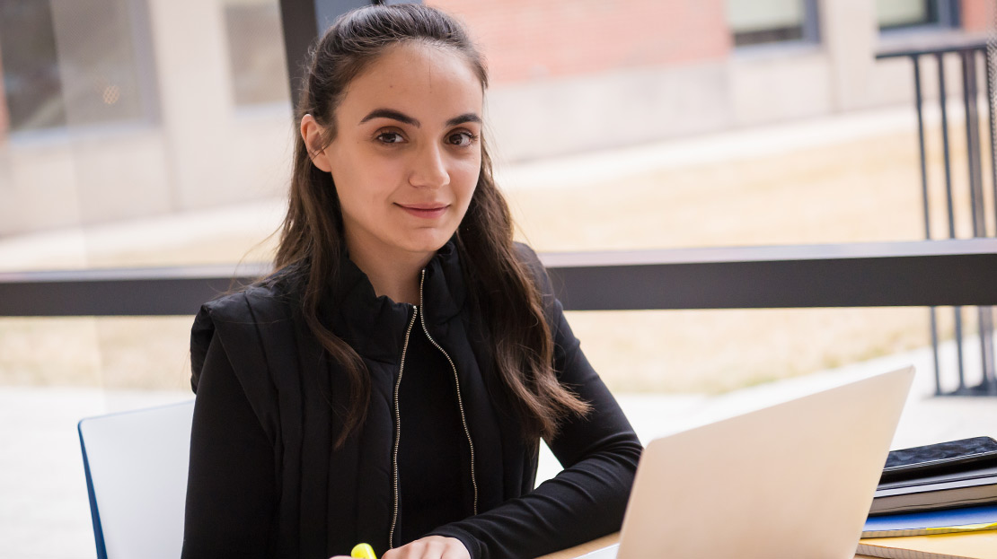 A student using a laptop.