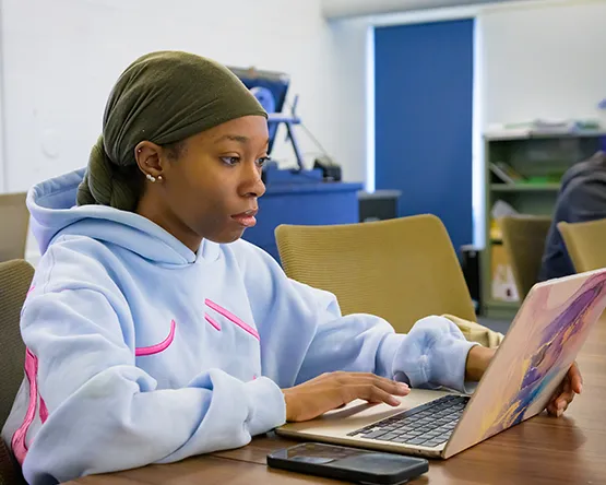 Woman focused on her work using a laptop.