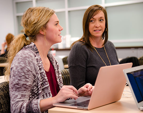 Students collaborate on laptop